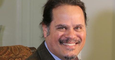 Dr. Steve Katsikas, seated, smiling, professional headshot
