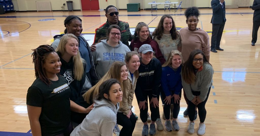 Master P poses for photos with a group of Spalding womens volleyball players